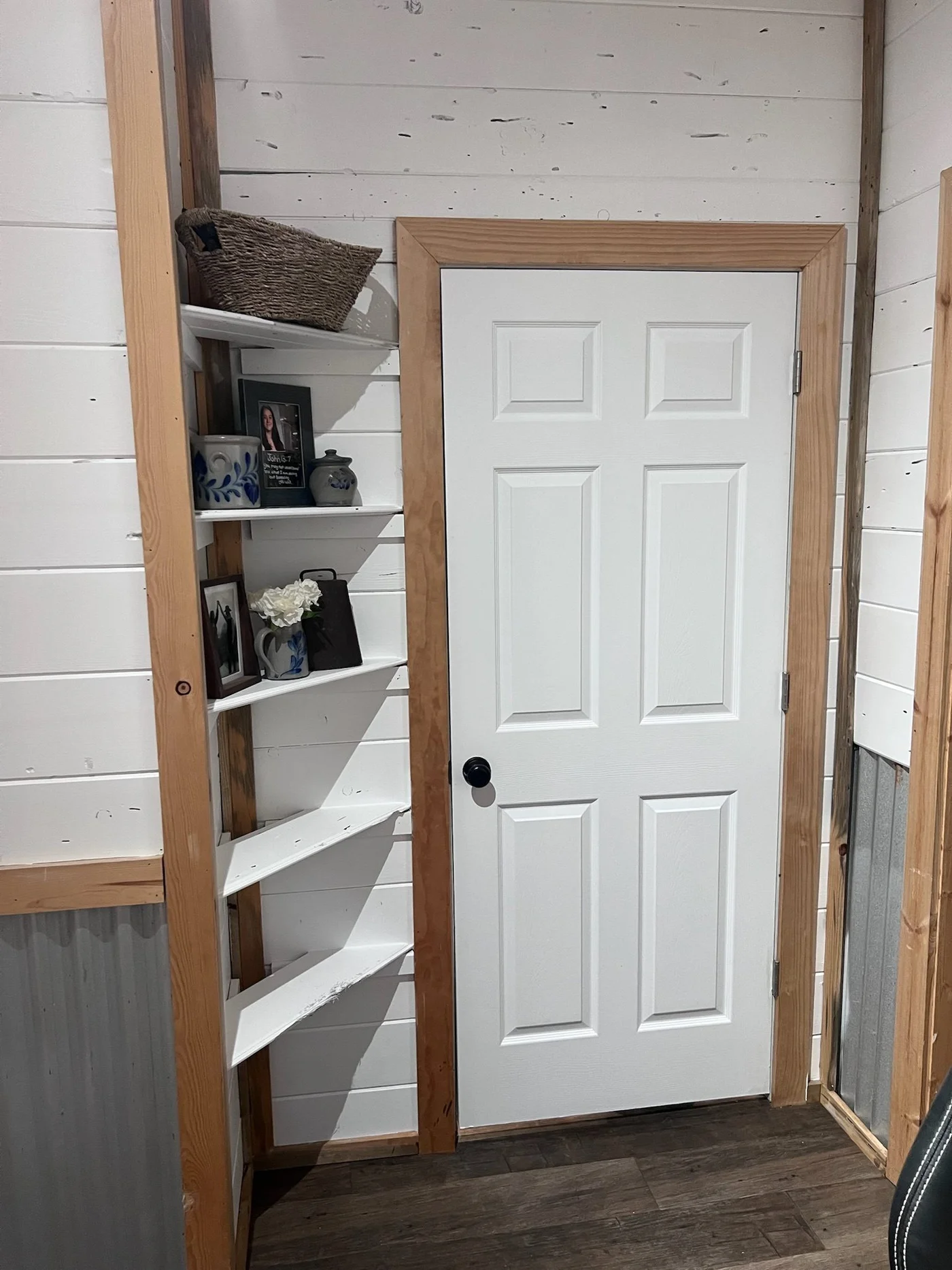 Tiny home corner shelving with shiplap walls and pine trim