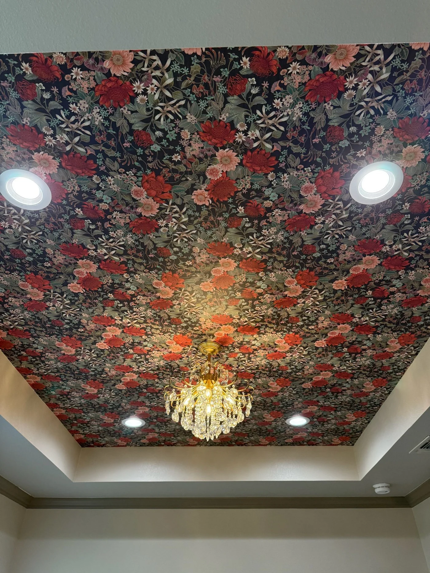 Primary bath floral wallpapered tray ceiling with crystal chandelier