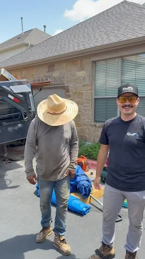 Will Christensen with a crew member on a job site — You learn something new every day on a roof.