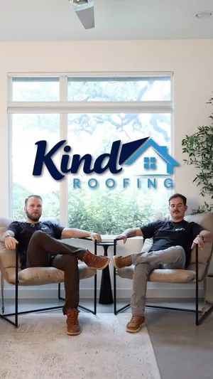 Will Christensen and Noah Brust seated in front of the Kind Roofing logo — Who we are, and why we started Kind Roofing.