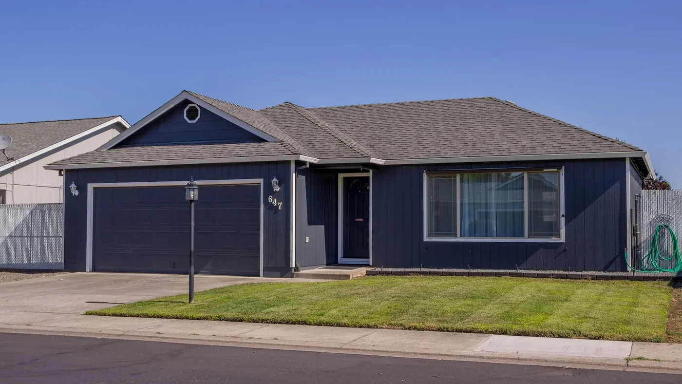 Single-story California ranch-style home with a long, low-pitched roof and attached garage