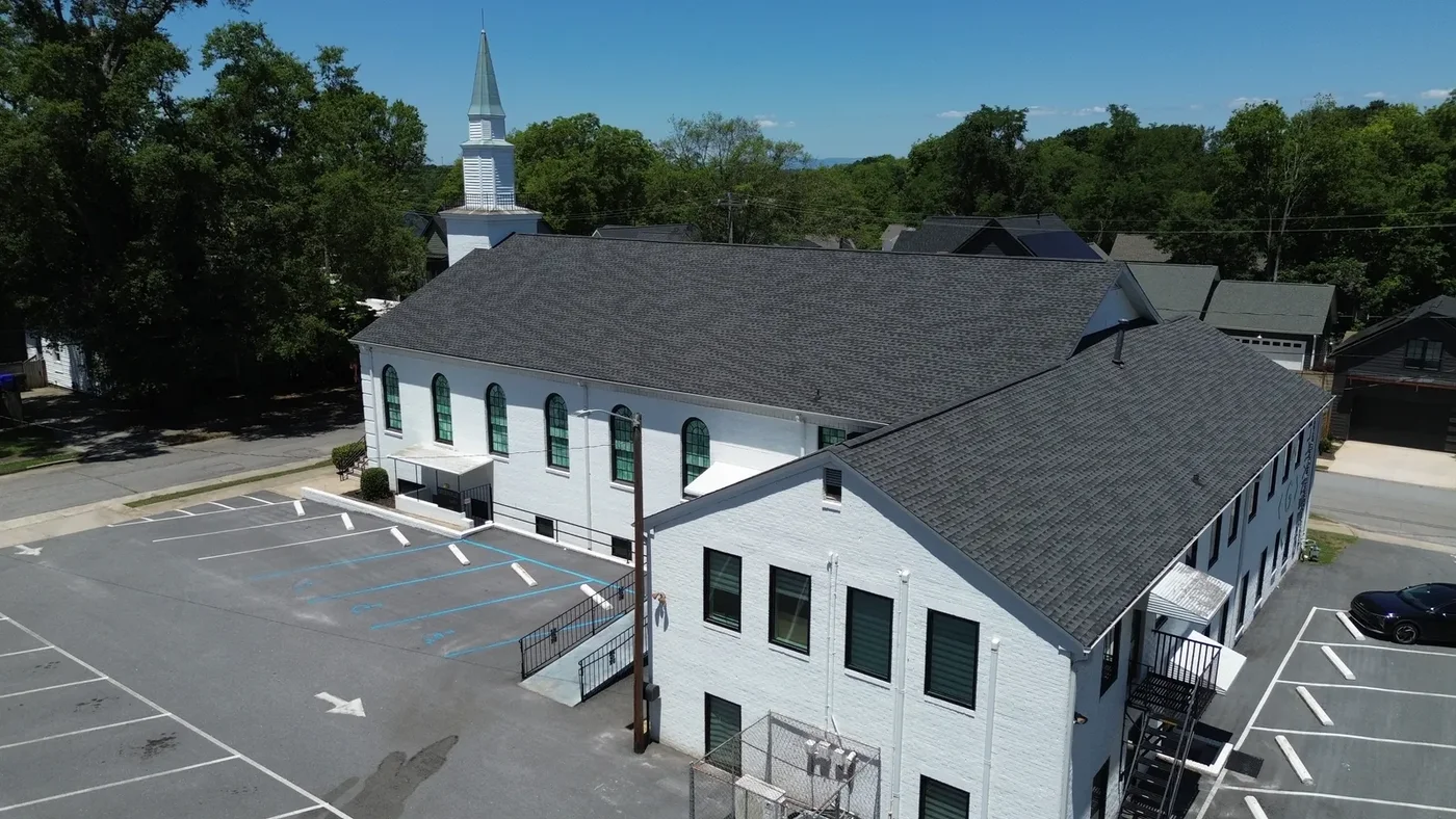 Renovated sanctuary wing of Greenville Community Church with arched windows and a white steeple