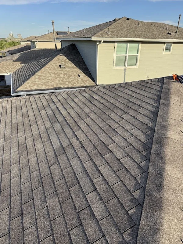 The repaired section of shingle roof