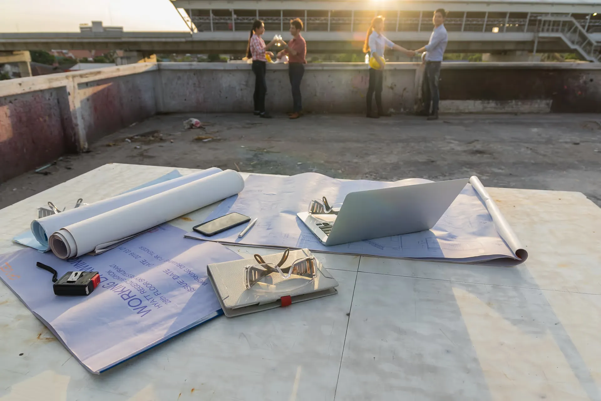 people standing on a flat roof top under construction