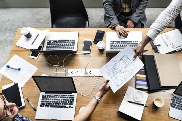 An event team working through plans and layouts at a table