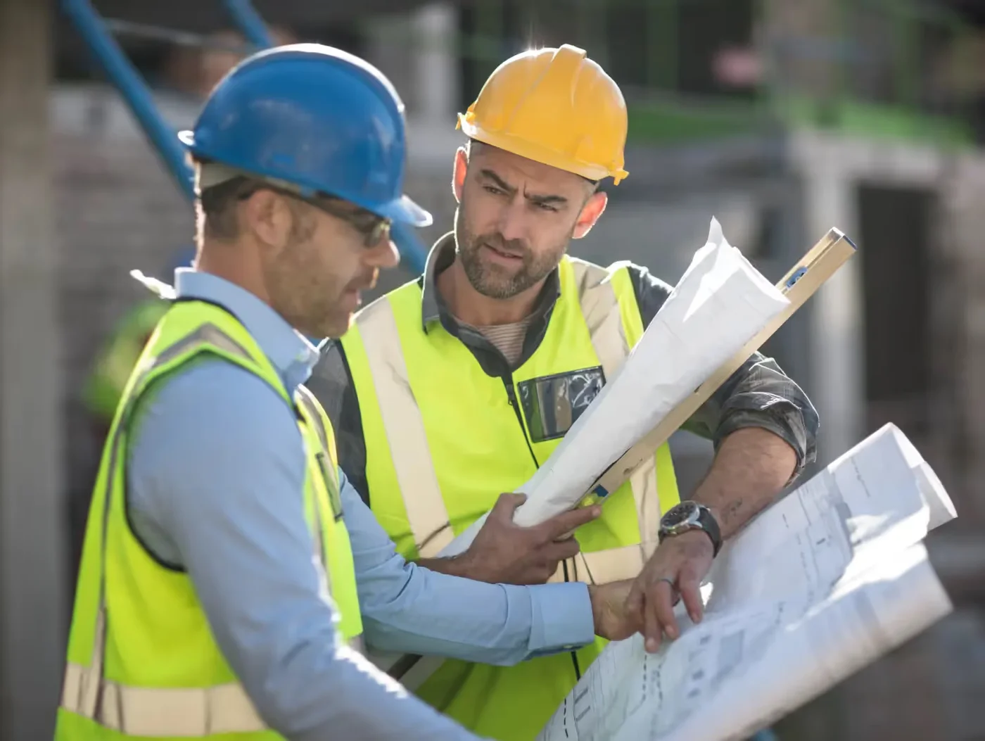 project manager and construction worker looking at blueprints