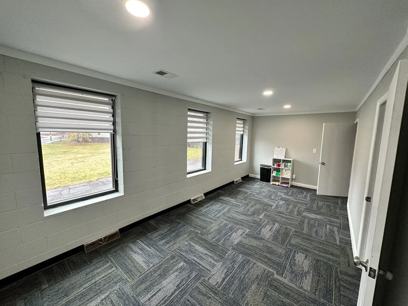 Remodeled open-concept living room with herringbone flooring
