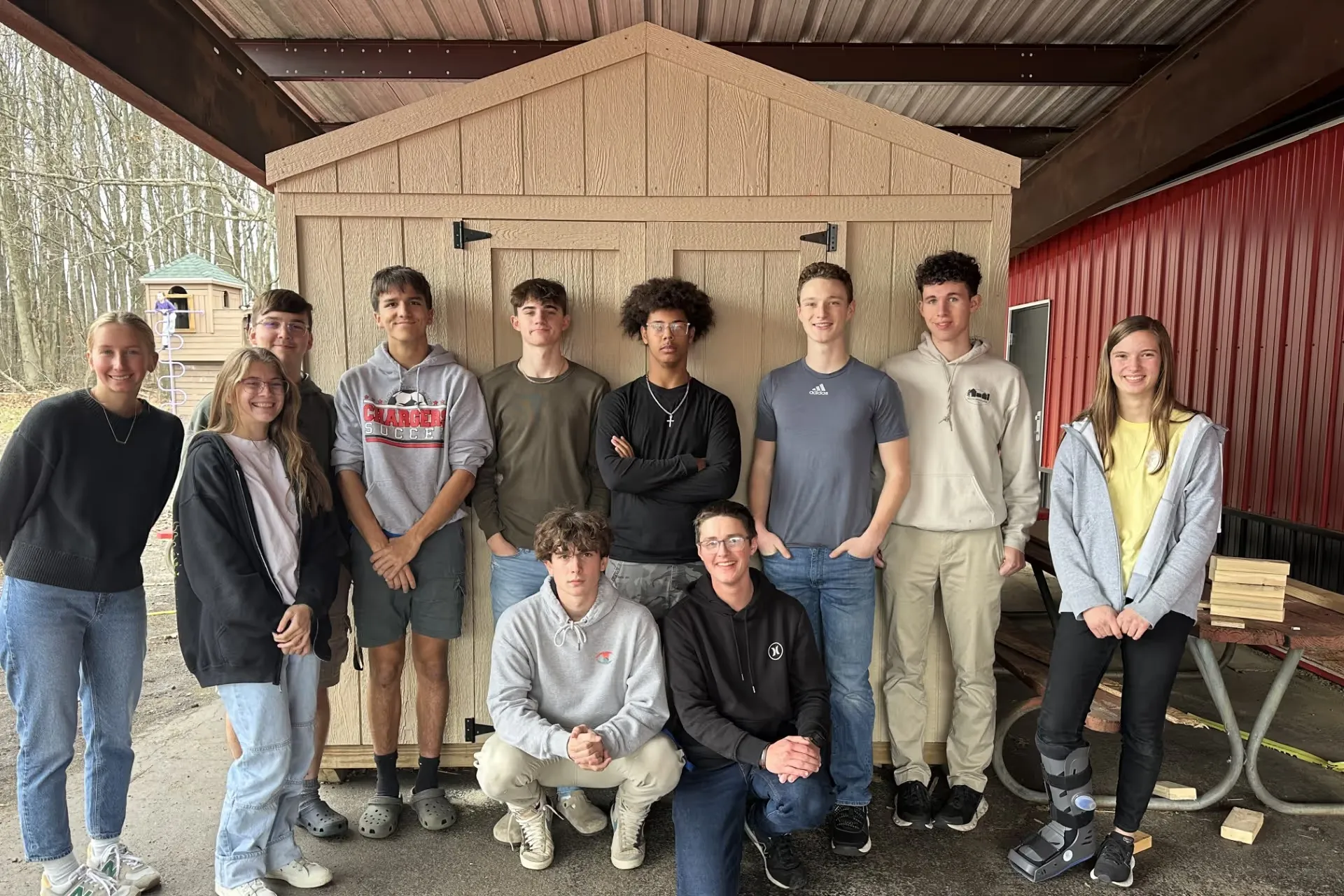 Students at Crawford Christian Academy standing in front of the donated Best Barns shed