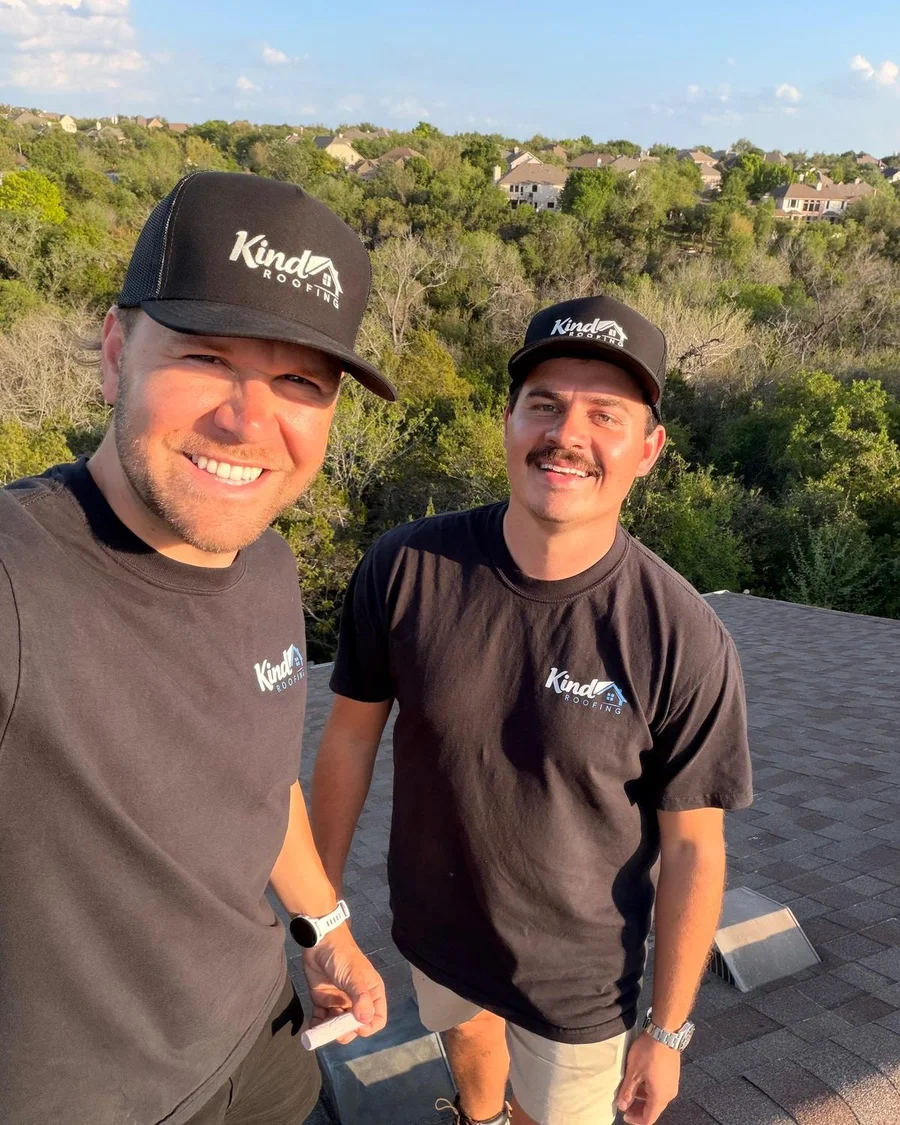 Noah Brust and Will Christensen, the founders of Kind Roofing, on a roof in Austin