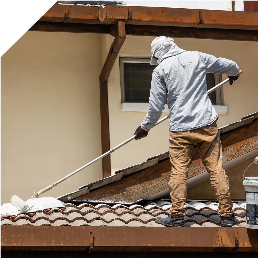 worker cleaning a shingled residential roof