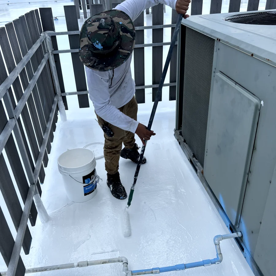 worker coating a commercial roof
