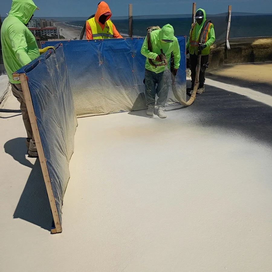 workers applying a spray foam roof coating