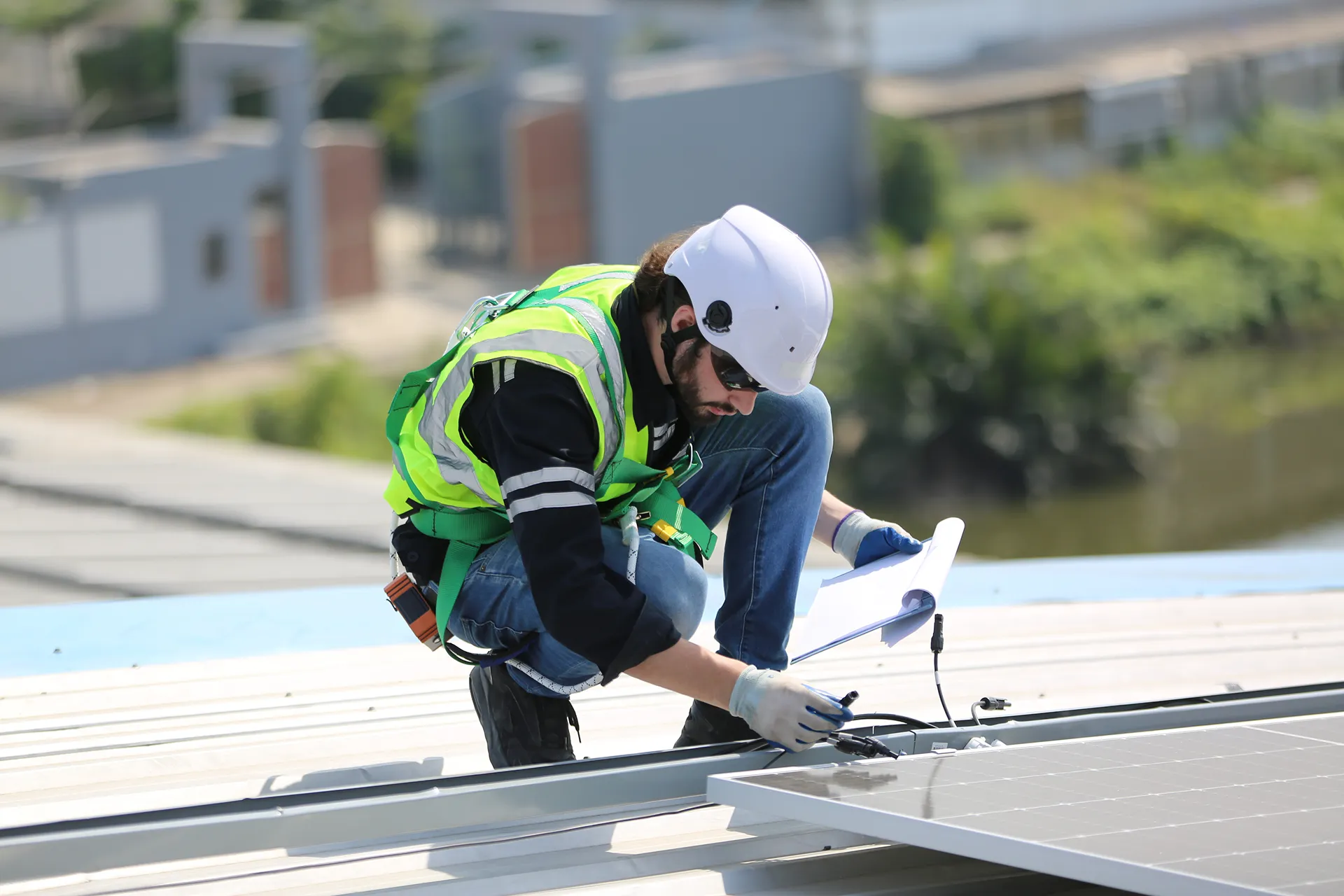workers-installing-solar-panels-on-warehouse-roof